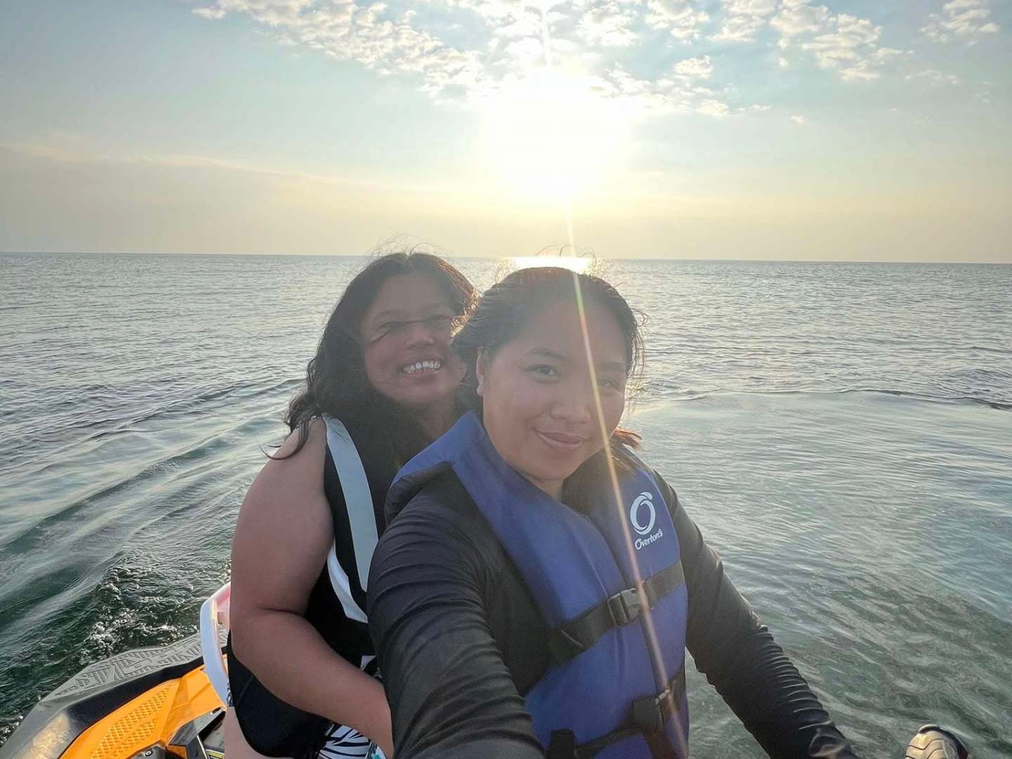 a woman standing next to a body of water
